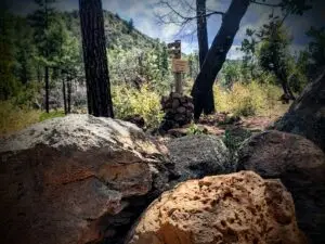 Rocks in foreground trail head sign in background